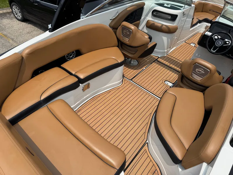 Slide: The Image of 2023 Crownline 280 SS SURF boat interior with tan leather seating and wood-style flooring. - 3