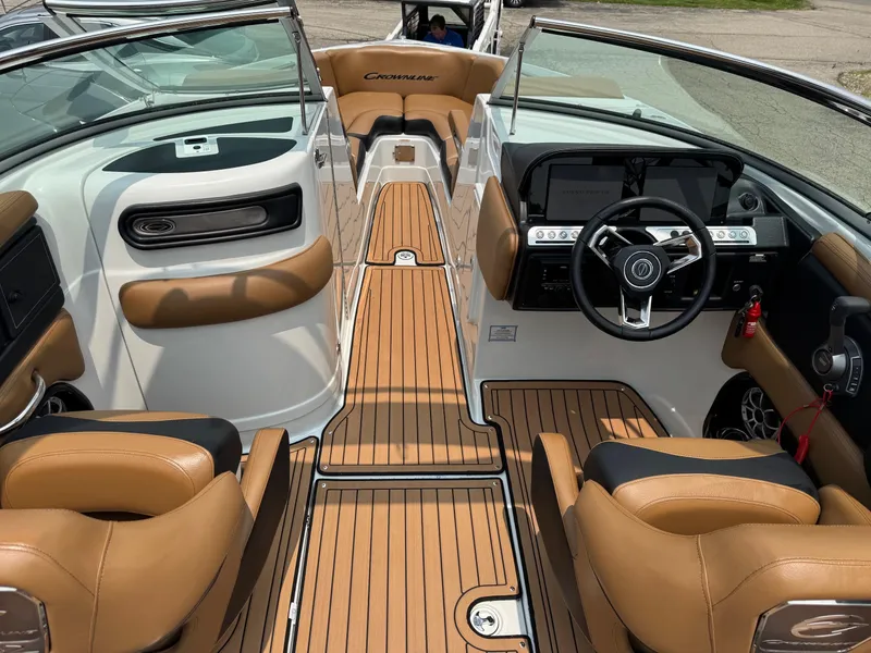 Slide: The Image of 2023 Crownline 280 SS SURF boat interior with tan leather seats and modern dashboard. - 7