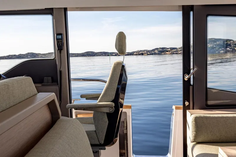 Slide: The Image of Interior view of 2025 Nimbus 495 Flybridge yacht with scenic ocean backdrop. - 10