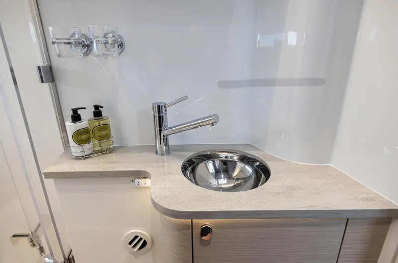 Slide: The Image of Modern bathroom sink in 2025 Nimbus 495 Flybridge yacht, featuring sleek faucet and toiletries. - 13