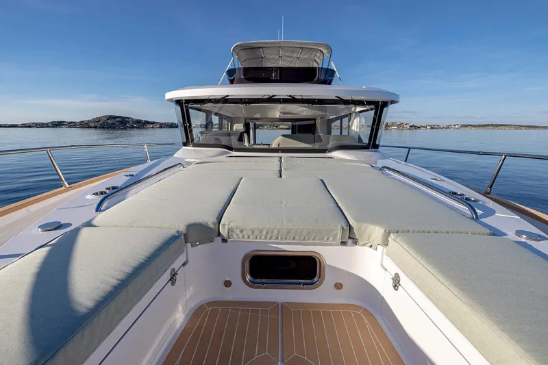 Slide: The Image of 2025 Nimbus 495 Flybridge yacht with spacious deck and sleek design on calm waters. - 15