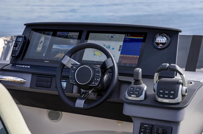 Slide: The Image of 2025 Nimbus 495 Flybridge helm with advanced navigation and control systems. - 18