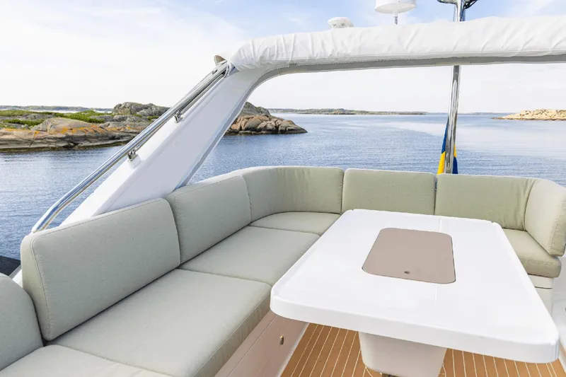 Slide: The Image of Luxurious seating area on 2025 Nimbus 495 Flybridge yacht with scenic ocean view. - 19