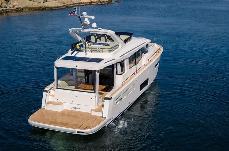 Slide: The Image of Nimbus 495 Flybridge 2025 yacht cruising on calm blue waters. - 32