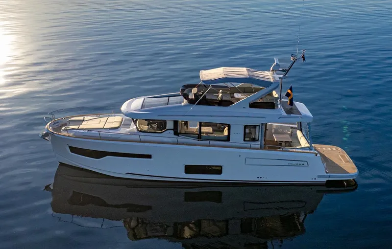 Slide: The Image of 2025 Nimbus 495 Flybridge yacht on calm water, showcasing sleek design and modern features. - 36