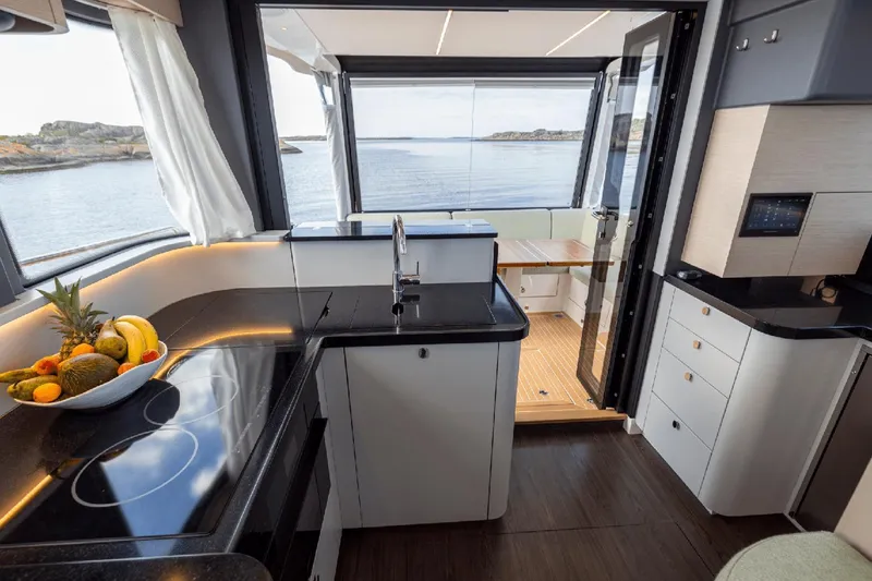 Slide: The Image of Luxurious kitchen interior of 2025 Nimbus 495 Flybridge yacht with ocean view. - 6