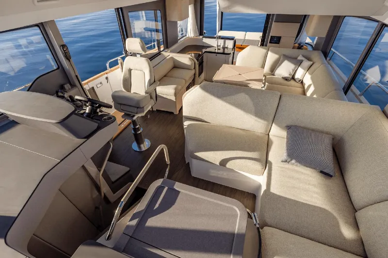 Slide: The Image of Luxurious interior of 2025 Nimbus 495 Flybridge yacht with modern seating and panoramic windows. - 8
