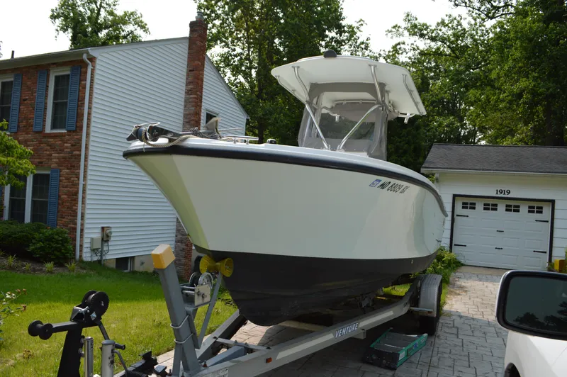 Slide: The Image of 2007 Edgewater 228CC boat on trailer in residential driveway. - 0