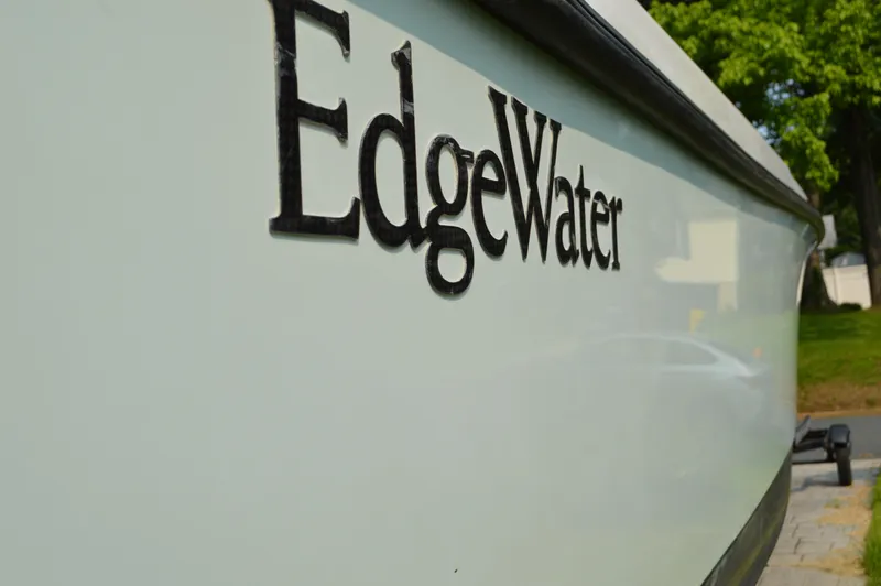Slide: The Image of Side view of a 2007 Edgewater 228CC boat with logo. - 1