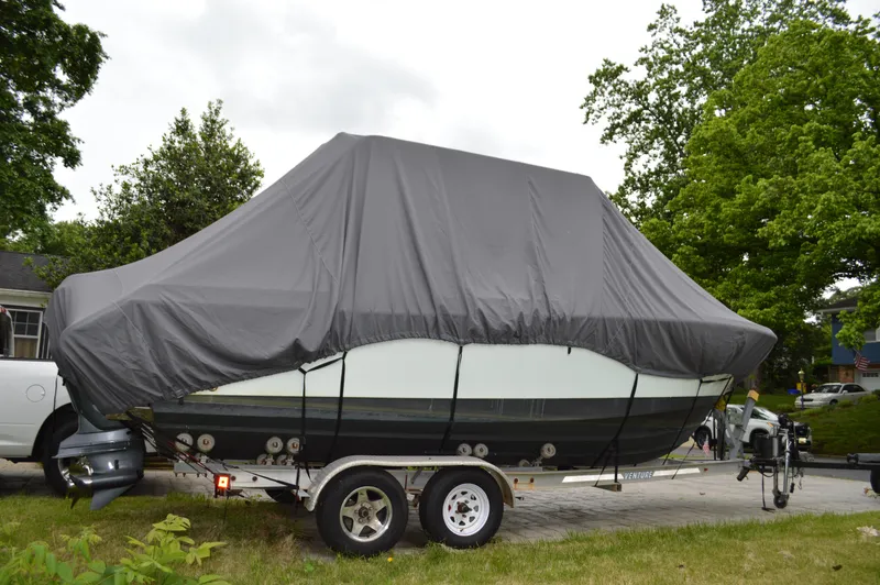 Slide: The Image of Covered 2007 Edgewater 228CC boat on trailer, parked outdoors. - 10