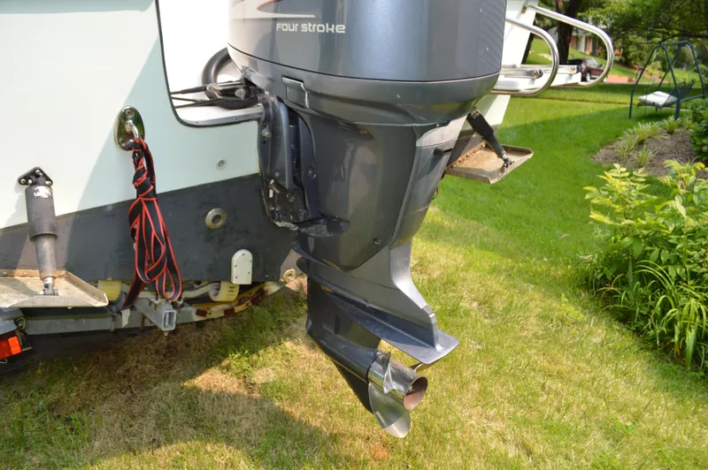 Slide: The Image of 2007 Edgewater 228CC boat with four-stroke outboard motor on grassy area. - 12
