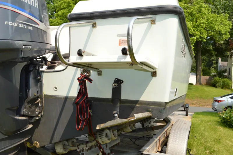Slide: The Image of 2007 Edgewater 228CC boat on trailer with Yamaha four-stroke engine, parked outdoors. - 13