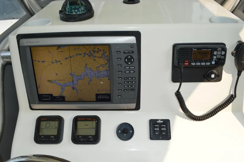Slide: The Image of Dashboard of 2007 Edgewater 228CC with navigation and communication equipment. - 16