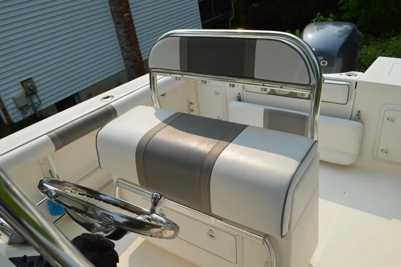 Slide: The Image of 2007 Edgewater 228CC boat interior with steering wheel and cushioned seating. - 18