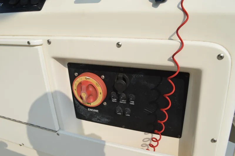 Slide: The Image of Control panel of a 2007 Edgewater 228CC boat with safety lanyard and switches. - 19