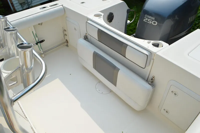 Slide: The Image of 2007 Edgewater 228CC boat interior with Yamaha 250 engine, featuring seating and rod holders. - 20