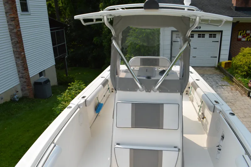 Slide: The Image of 2007 Edgewater 228CC boat with T-top, parked in residential driveway. - 22