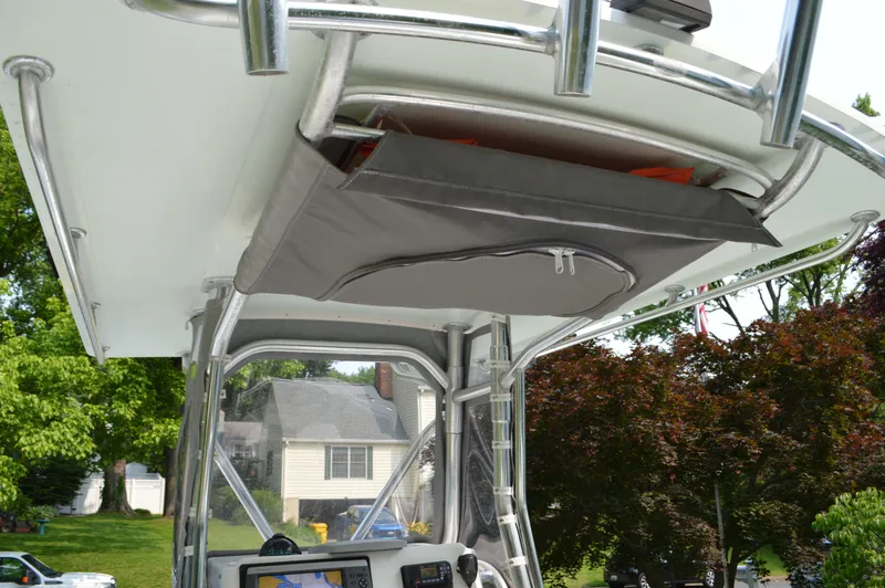 Slide: The Image of 2007 Edgewater 228CC boat with T-top storage and navigation equipment. - 26