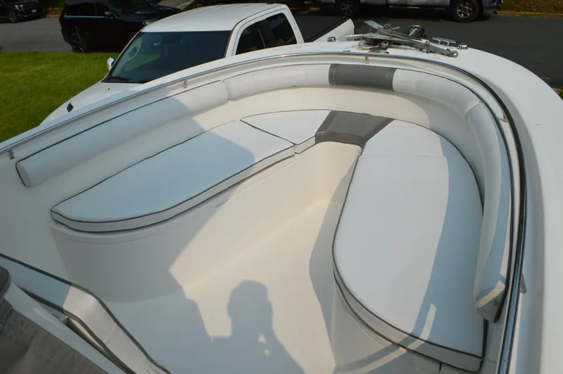 Slide: The Image of 2007 Edgewater 228CC boat with spacious white seating area and sleek design. - 31