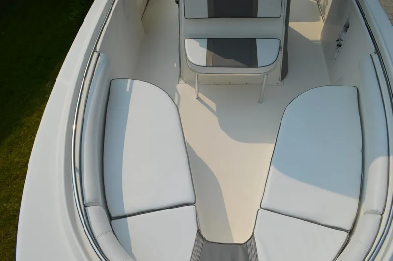 Slide: The Image of 2007 Edgewater 228CC boat interior with cushioned seating and clean design. - 32