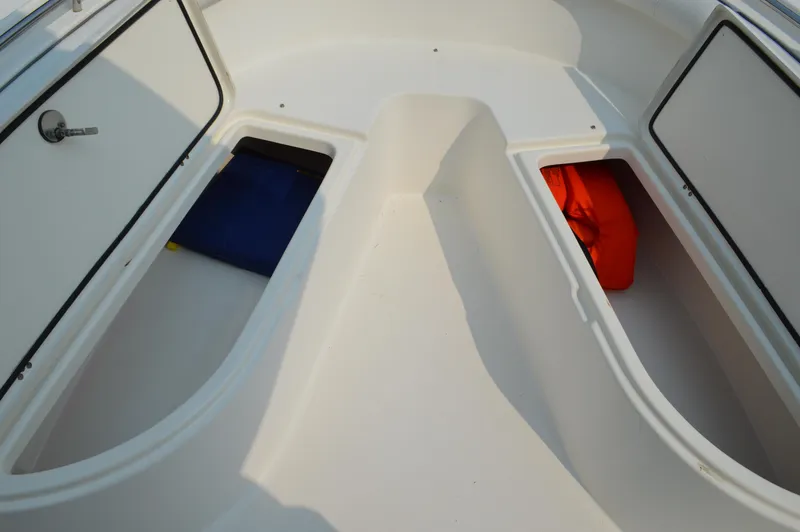 Slide: The Image of 2007 Edgewater 228CC boat storage compartments with life jackets. - 33