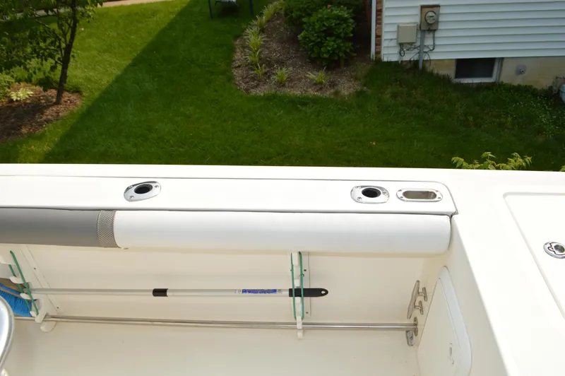 Slide: The Image of 2007 Edgewater 228CC boat interior with rod holders and cushioned seating. - 36