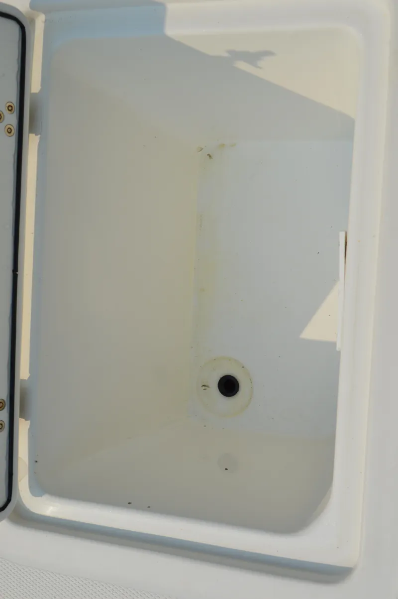 Slide: The Image of Edgewater 228CC 2007 boat storage compartment, open and empty. - 43