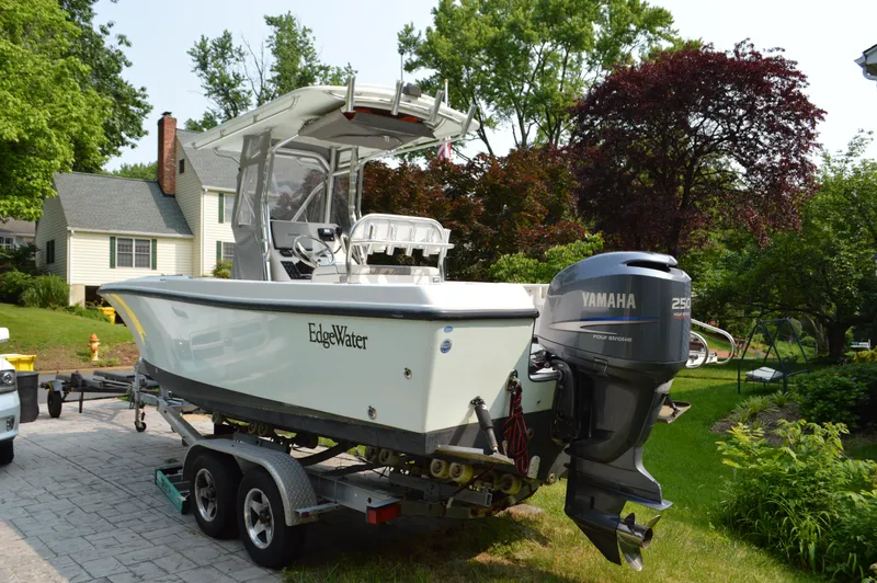 Slide: The Image of 2007 Edgewater 228CC boat with Yamaha engine on trailer in residential driveway. - 5