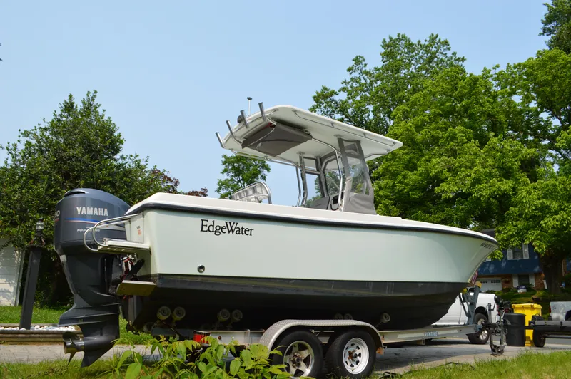 Slide: The Image of 2007 Edgewater 228CC boat on trailer with Yamaha outboard, parked outdoors. - 7