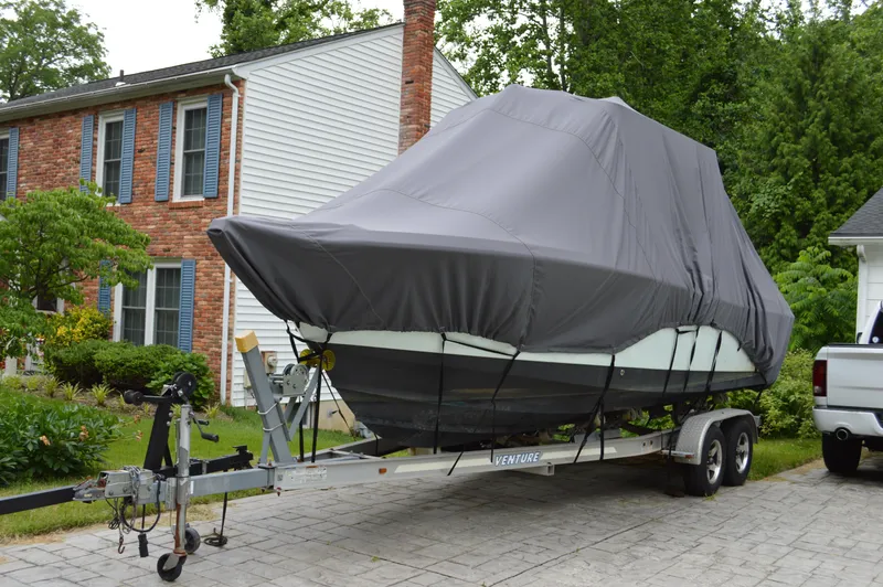 Slide: The Image of Covered 2007 Edgewater 228CC boat on trailer in residential driveway. - 8