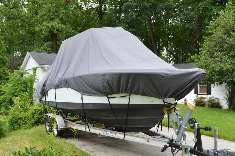 Slide: The Image of Covered 2007 Edgewater 228CC boat on trailer in residential driveway. - 9