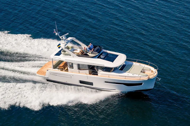 Slide: The Image of 2025 Nimbus 495 Flybridge yacht cruising on open water. - 1