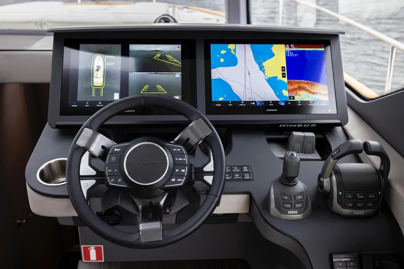 Slide: The Image of 2025 Nimbus 495 Flybridge helm with advanced navigation displays and controls. - 11