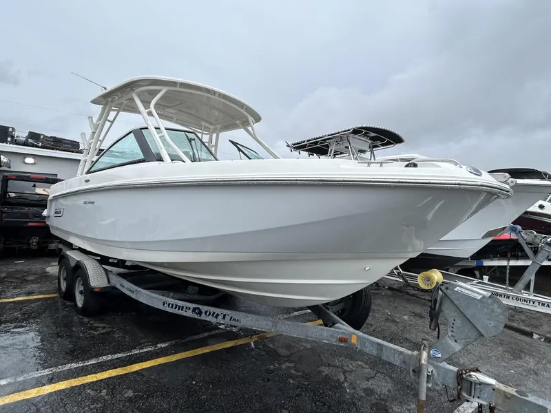 Slide: The Image of 2018 Boston Whaler 230 Vantage boat on trailer, parked outdoors on a cloudy day. - 3