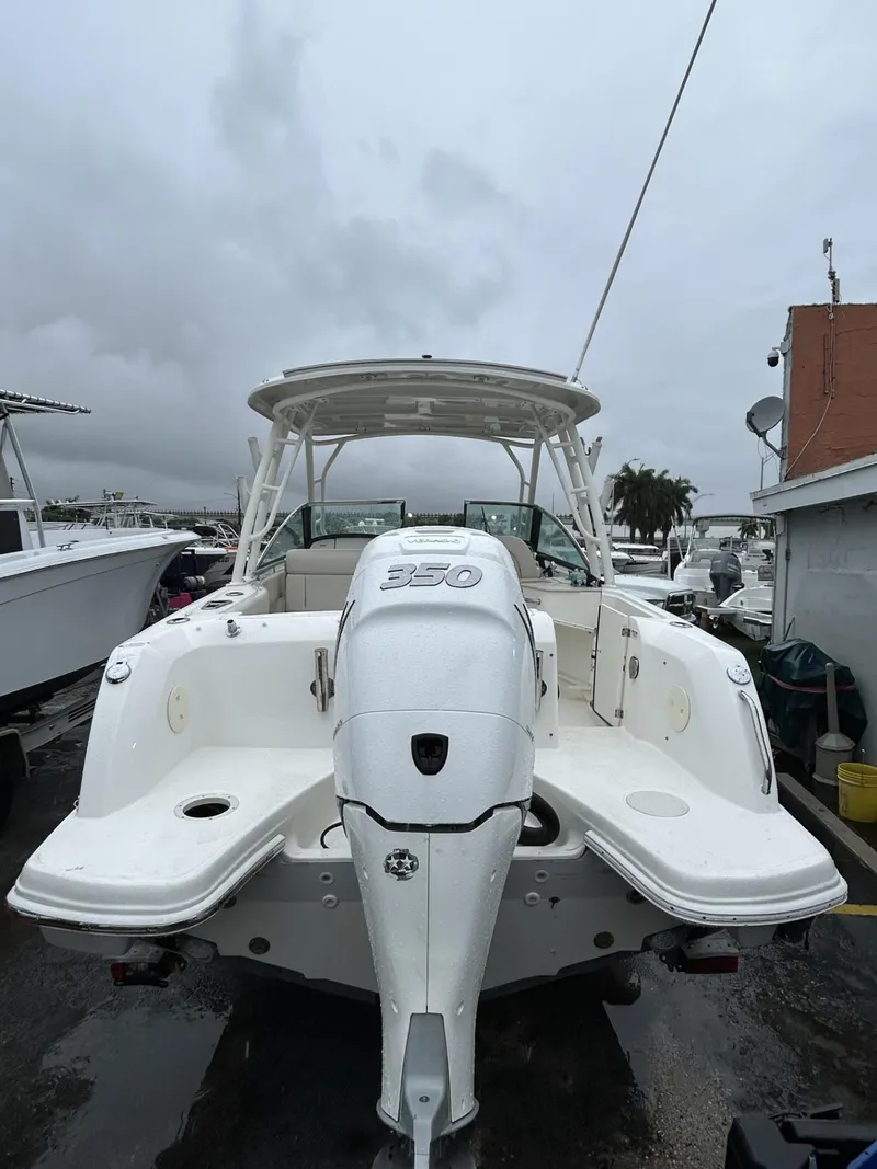 Slide: The Image of 2018 Boston Whaler 230 Vantage boat, rear view, docked on a cloudy day. - 5