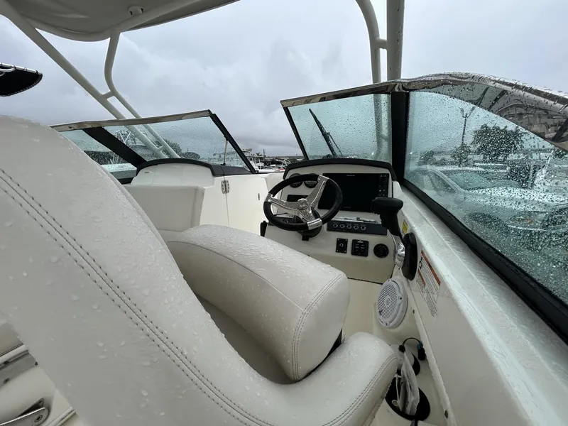 Slide: The Image of 2018 Boston Whaler 230 Vantage boat interior with wet seats and steering wheel. - 6