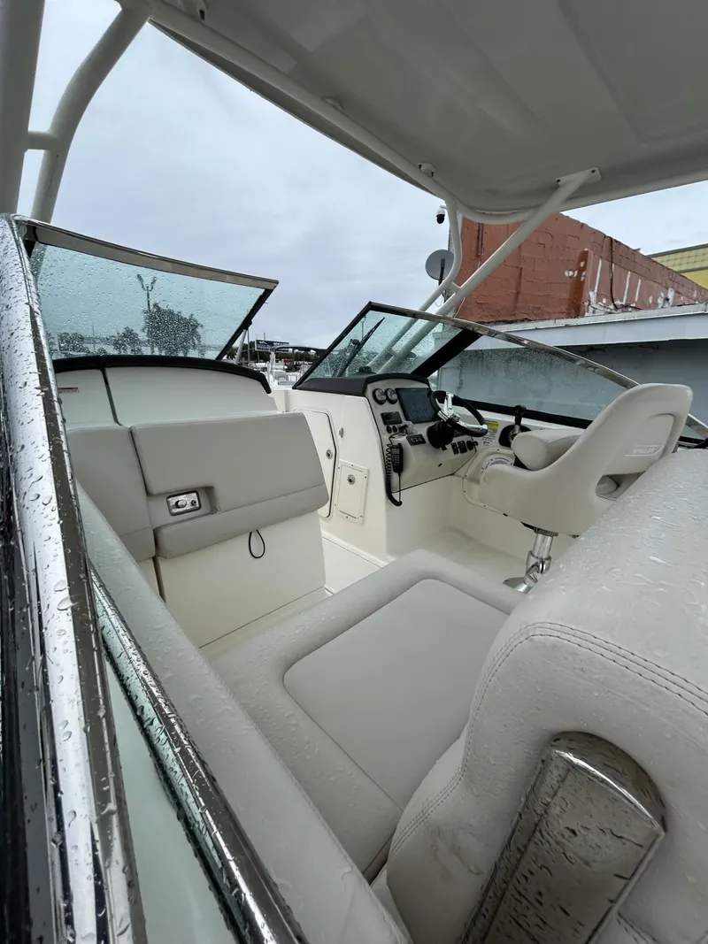 Slide: The Image of 2018 Boston Whaler 230 Vantage boat interior with wet seats and dashboard controls. - 8