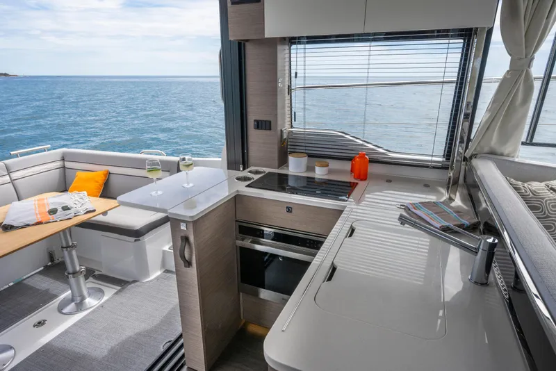 Slide: The Image of Interior of 2026 Jeanneau NC1295 Fly yacht with modern kitchen and ocean view. - 3