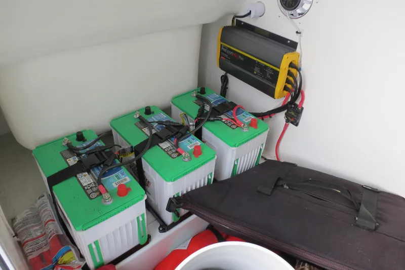 Slide: The Image of Battery compartment of 2022 Valentino 28CC with three green batteries and a charger. - 11