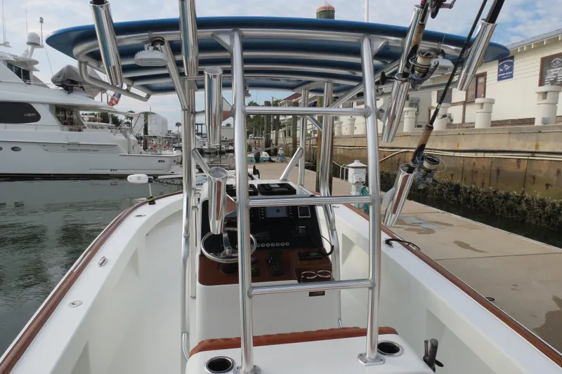 Slide: The Image of 2022 Valentino 28CC boat docked, featuring a sleek center console and stainless steel framework. - 17