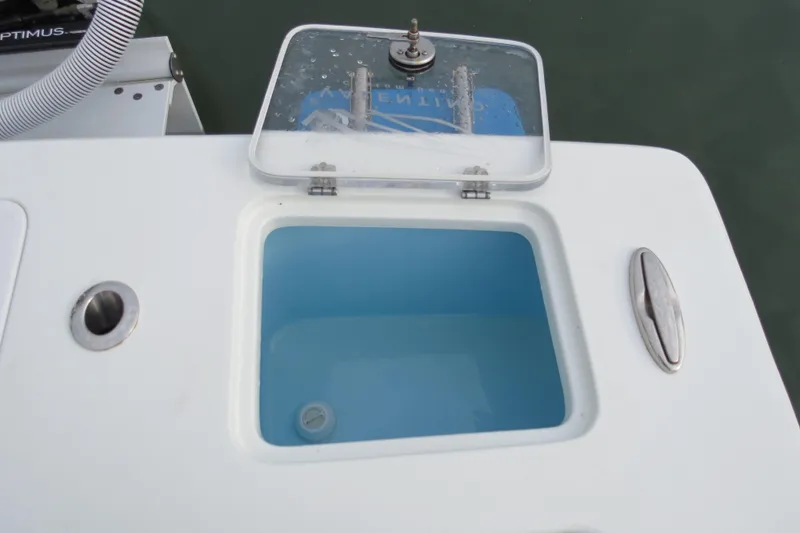 Slide: The Image of Valentino 28CC 2022 boat livewell with open lid, showing blue water inside. - 20