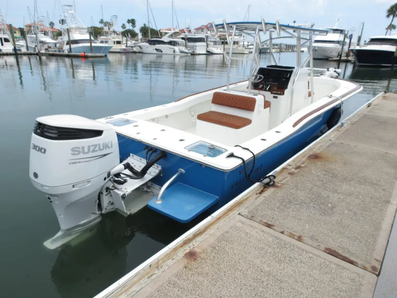 Slide: The Image of Valentino 28CC 2022 boat docked, featuring Suzuki 300 engine, in a marina setting. - 24