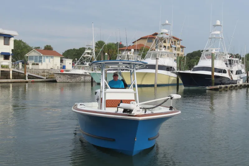 Slide: The Image of 2022 Valentino 28CC boat in marina, surrounded by other vessels. - 3