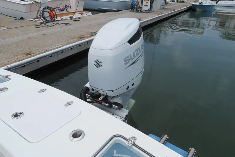 Slide: The Image of Valentino 28CC 2022 boat with Suzuki outboard motor docked at marina. - 31