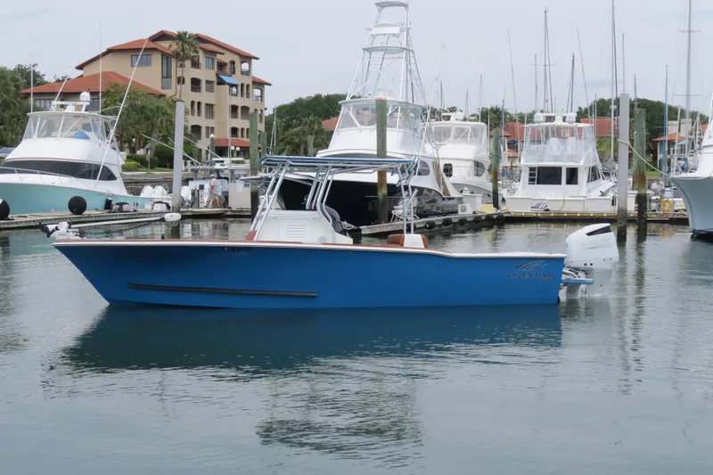 Slide: The Image of 2022 Valentino 28CC boat docked in a marina with other vessels. - 33