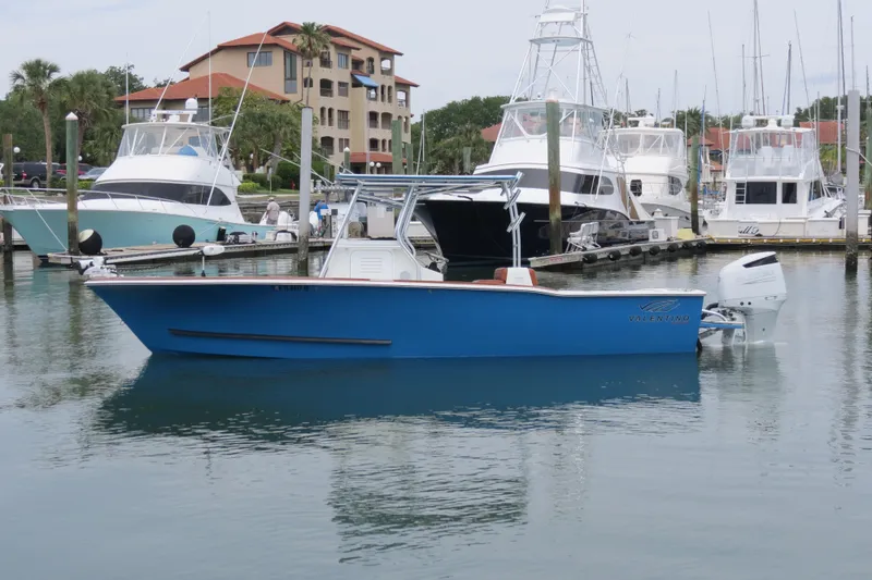 Slide: The Image of Blue Valentino 28CC boat docked in marina, 2022 model, surrounded by other yachts. - 34