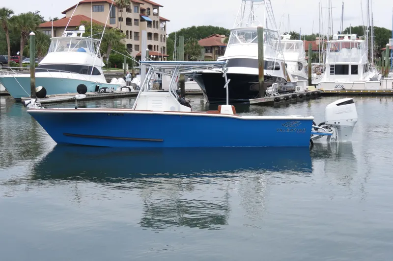 Slide: The Image of Blue 2022 Valentino 28CC boat docked in marina with other yachts. - 35