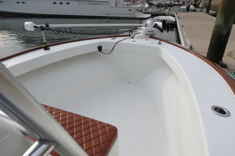 Slide: The Image of 2022 Valentino 28CC boat with brown seating, docked at marina. - 9