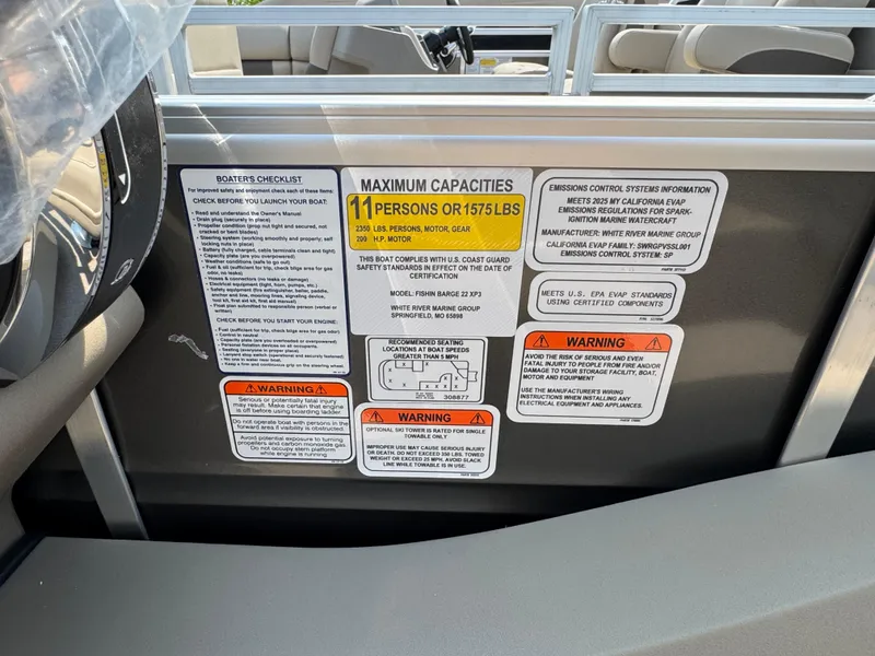 Slide: The Image of 2025 Sun Tracker Fishin' Barge 22 XP3 capacity and safety labels on boat interior. - 15