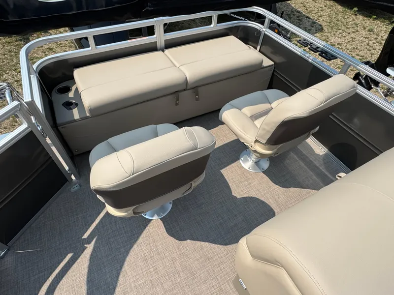 Slide: The Image of 2025 Sun Tracker Fishin' Barge 22 XP3 interior with beige seating and spacious layout. - 17